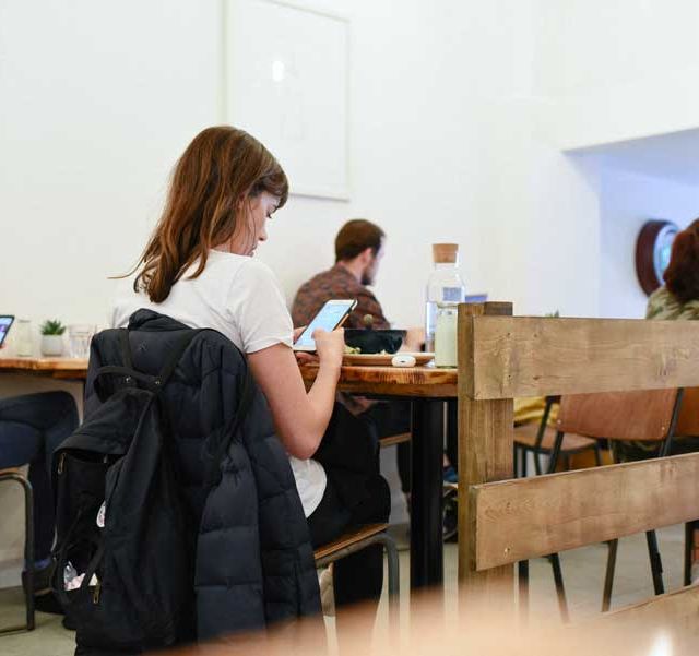 Patrons enjoying a meal in Social Fabric Café